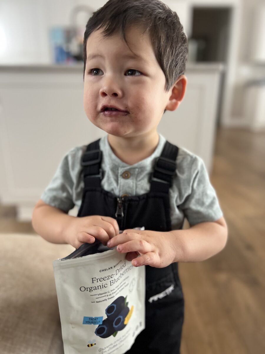 Lifestyle of two year old with organic freeze-dried blueberries from Chelan Ranch Organics